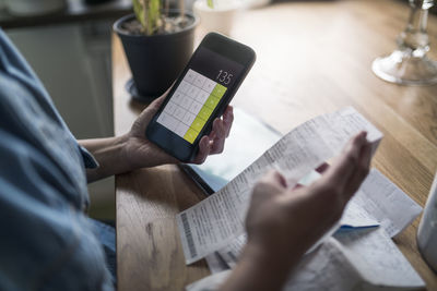 Woman organizing household budget with calculator