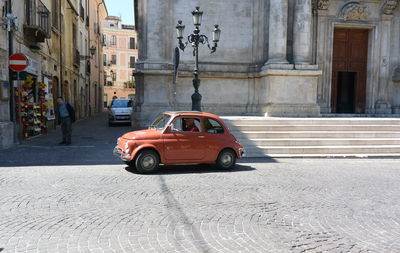 Vintage car on street against building