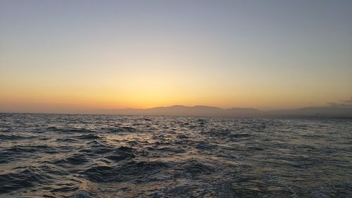 Scenic view of sea against clear sky during sunset