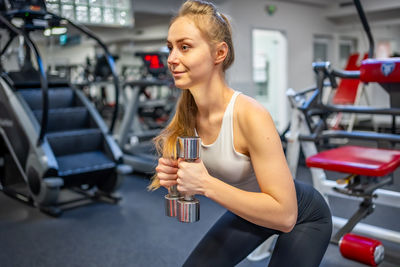 Young woman exercising in gym