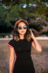 Portrait of a beautiful young woman wearing sunglasses