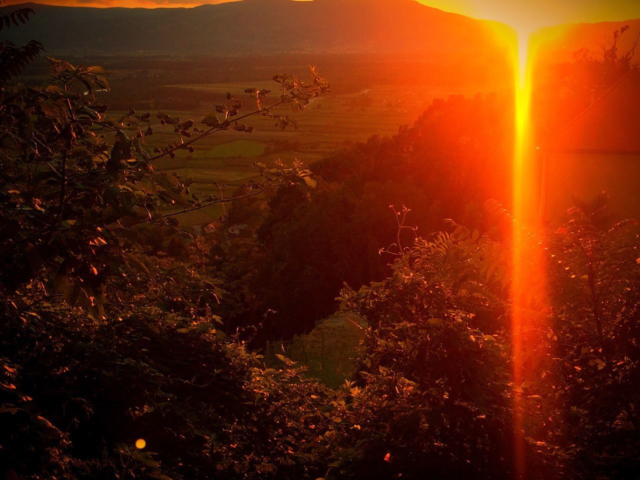 sun, sunset, tranquil scene, scenics, tranquility, beauty in nature, sunlight, lens flare, nature, sunbeam, landscape, idyllic, high angle view, orange color, sky, non-urban scene, outdoors, field, remote, no people