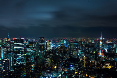 High angle view of illuminated city against sky at night