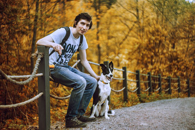 Handsome adult man is posing together with his dog