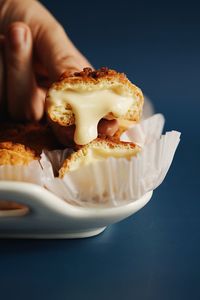 Close-up of hand holding cream puff