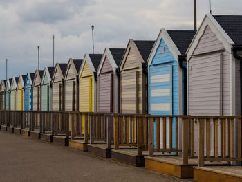 Row of beach huts on norfolk coast cloudy sky