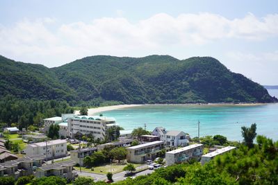 High angle view of buildings by sea against sky