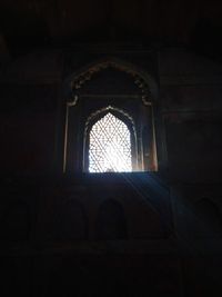 Low angle view of ornate window in old building