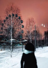 Rear view of person on snow covered field against sky