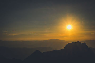 Scenic view of silhouette mountains against sky during sunset