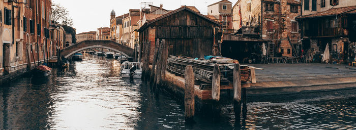 Canal amidst old buildings in city