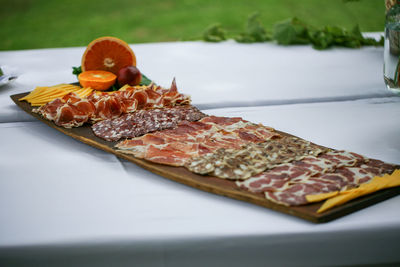 Various cold cuts served in plate on table