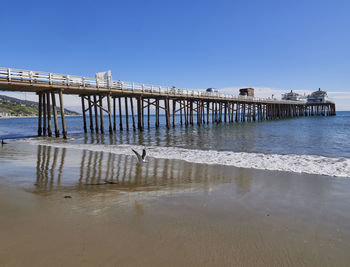 Pier over sea against clear sky