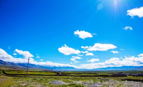 Scenic view of landscape against blue sky