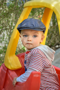 Portrait of cute boy in outdoor play equipment at playground