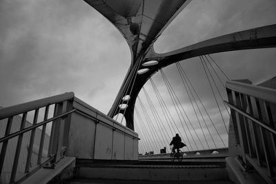 Low angle view of bridge against cloudy sky