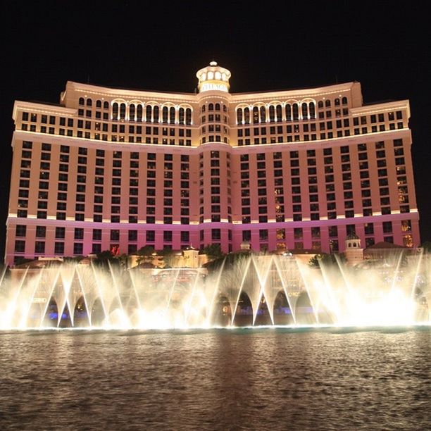 architecture, building exterior, built structure, night, water, illuminated, waterfront, fountain, reflection, city, motion, travel destinations, famous place, facade, tourism, sky, long exposure, outdoors, spraying, travel