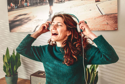 Portrait of happy young woman holding camera