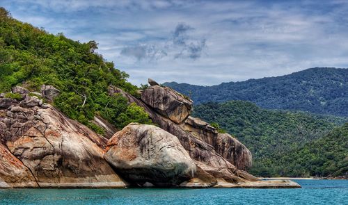 Scenic view of sea and mountains against sky