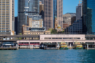 Sydney central quay, sydney harbour. bridge over river with buildings in background.