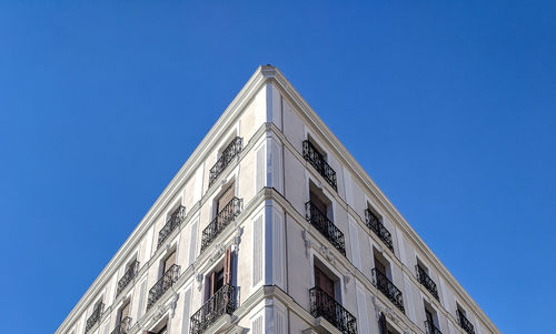 Low angle view of building against clear blue sky