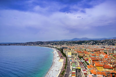 High angle view of townscape by sea against sky