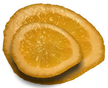 Close-up of lemon slice against white background