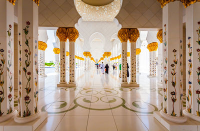 Reflection of people on tiled floor in building