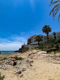 Scenic view of beach against blue sky