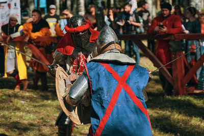 Rear view of people on field