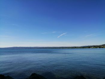 Scenic view of sea against clear blue sky