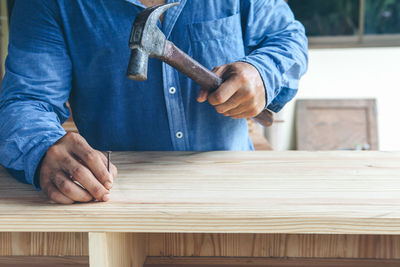 Man working on blue table
