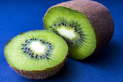 Close-up of green fruit against blue background