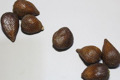 Close-up of fruits on table against white background