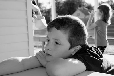 Close-up of thoughtful boy sitting outdoors