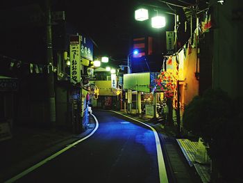 Illuminated road in city at night