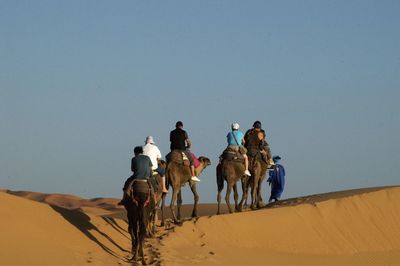 People riding horse in desert