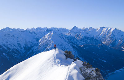 Scenic view of snowcapped mountains against clear sky