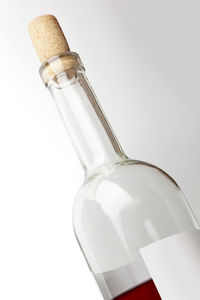 Close-up of glass bottle against white background