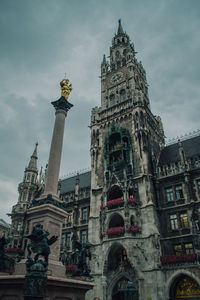 Low angle view of statue against cloudy sky