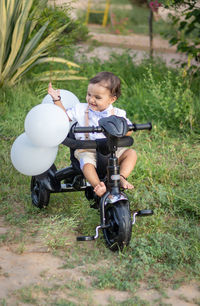 High angle view of boy riding push scooter on field