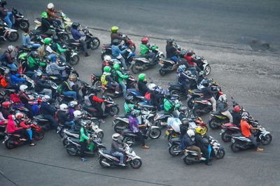 High angle view of people riding motorcycles on road