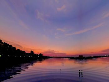 Scenic view of lake against sky during sunset