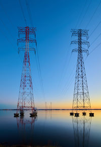 High voltage transmission lines crossing wheeler lake at dusk near athens al. 