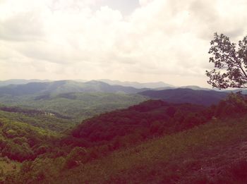 Scenic view of mountains against cloudy sky