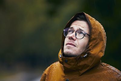 Close-up of man looking up while standing outdoors