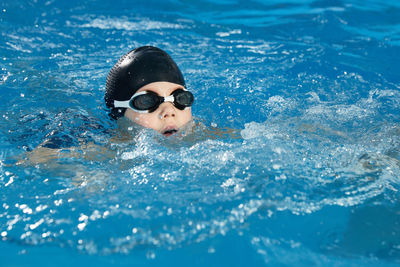 Portrait of woman swimming in pool