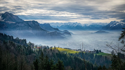 Scenic view of mountains against cloudy sky