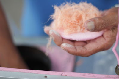 Cropped hand of senior woman holding sponge