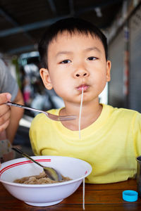 Portrait of boy eating food